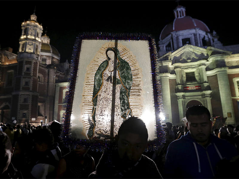A pilgrim holds up an image of the Virgin of Guadalupe at the Basilica of Guadalupe during an annual pilgrimage in honor of the Virgin, the patron saint of Mexican Catholics, in Mexico City, Mexico on Dec. 12, 2015. Photo courtesy of Reuters/Henry Romero