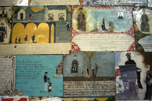 Retablos thanking Saint Francis of Assisi for miracles in the Templo de la Purisima Concepcion, the parish church or parroquia in the 19th-century mining town of Real de Catorce, Mexico. Real de Catorce became a virtual ghost town during the early part of the 20th century. It has recently become a popuar destination for travellers. It is also a Catholic pilgrimage site.