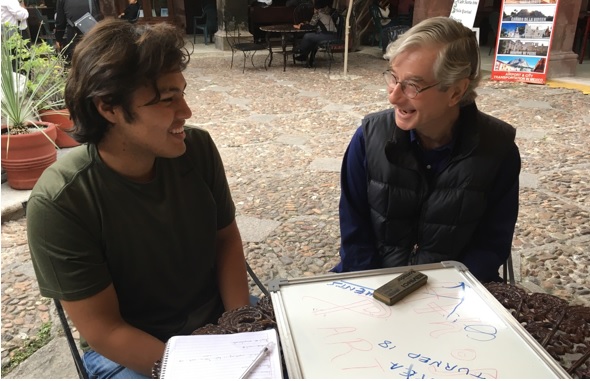 High School Student Saolo Isaias Duarte Matehuala speaking English with JA Volunteer Jock Whitehouse because he English is the most important skill local employers are seeking and JA seeks well-rounded high school graduates for its university scholarships. (Photo: Jóvenes Adelante)